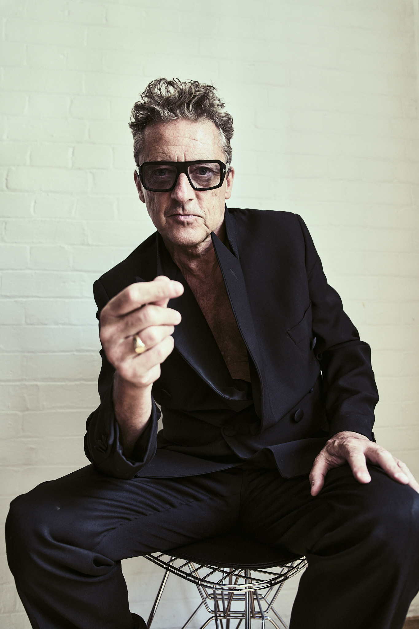 Jeremy Healy in a satin double-breasted jacket and Tom Ford glasses
